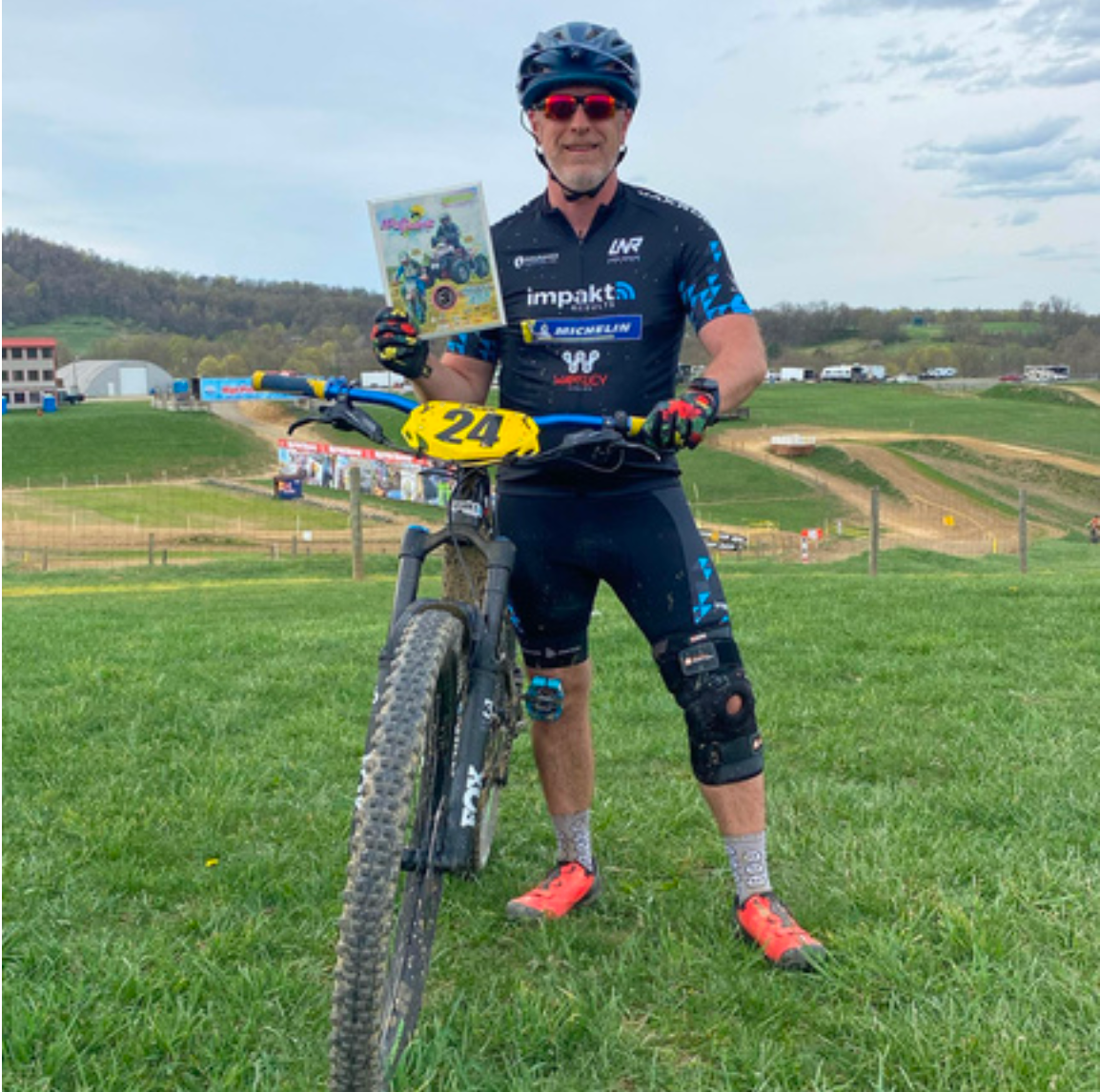 Original photo from Jeff's client spotlight showing a cyclist with his bicycle